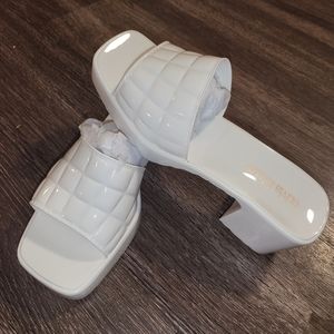 Brand new white heels. Never been worn still in the box.